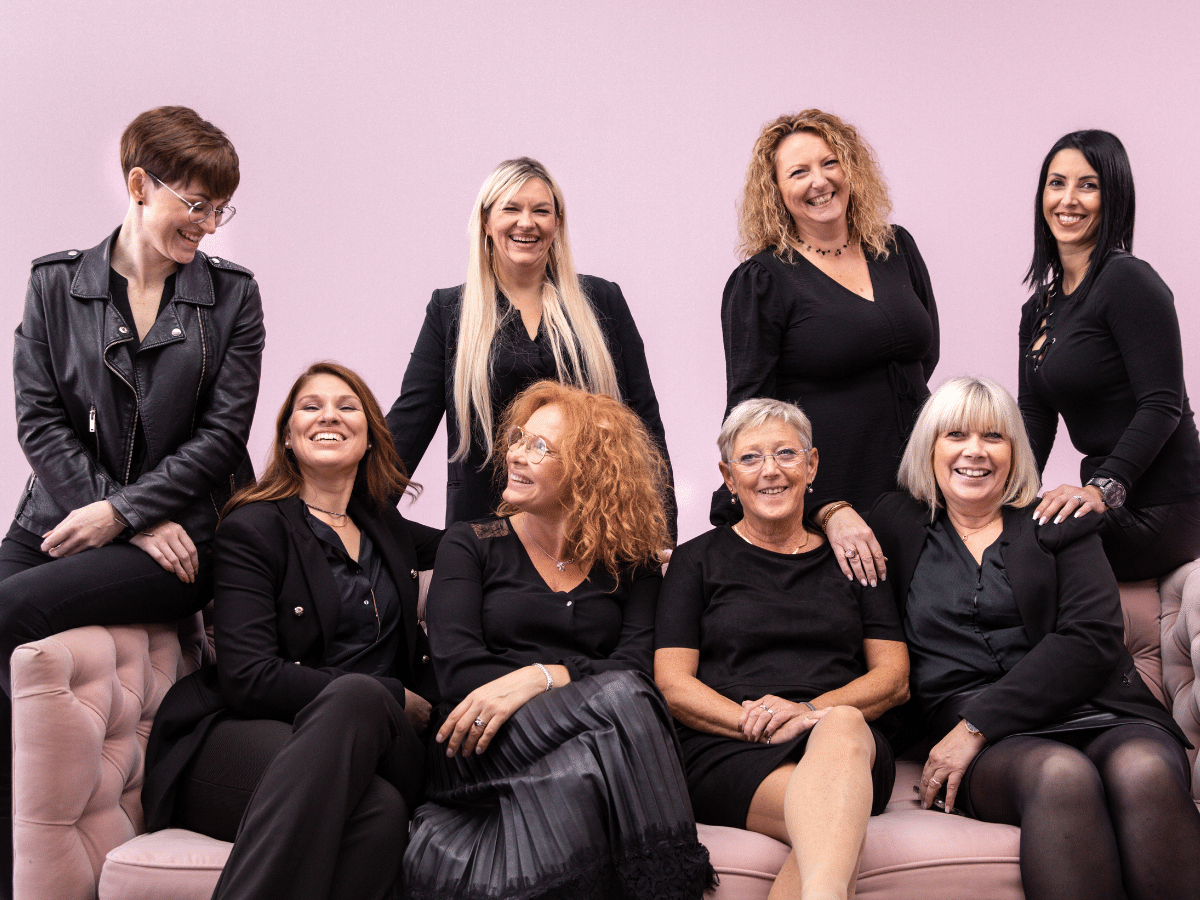 Mother and young daughter wearing hair pins smiling at each other